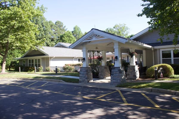 Covered entrance with landscaping at senior living facility