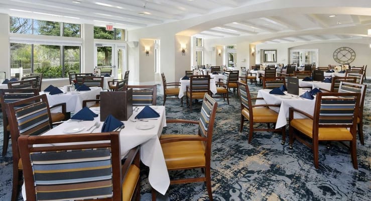 Elegant dining room with tables set for residents