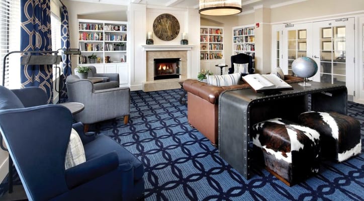 Cozy common area with bookshelves and a fireplace