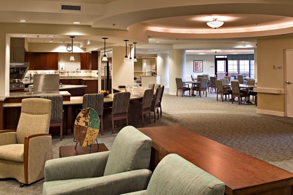 Bright common area with seating and dining tables