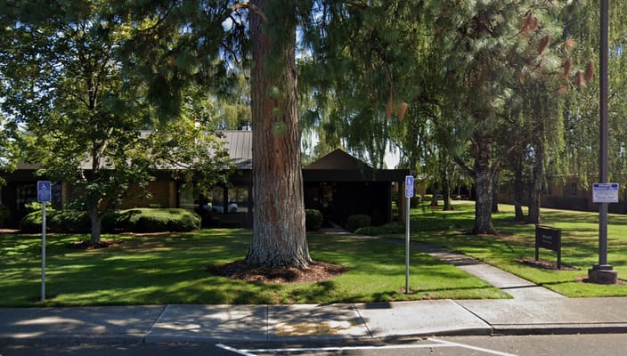 Exterior view of a senior living facility with landscaped garden