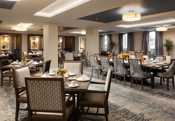 Elegant dining room with set tables and floral arrangements