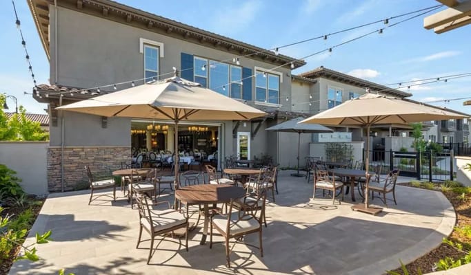 Outdoor seating area with tables and umbrellas