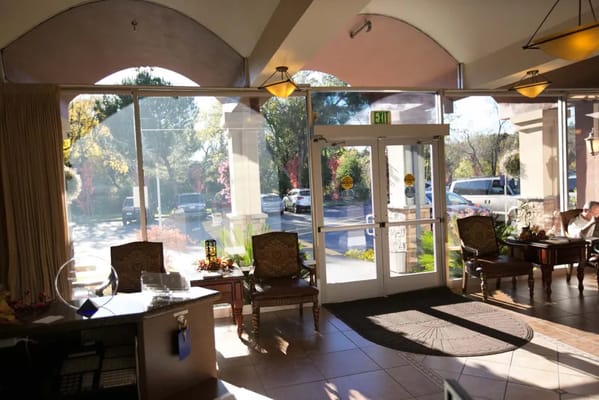 Bright interior lobby with seating and outdoor view