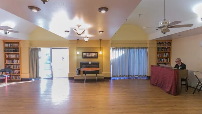 Common area with a resident playing piano