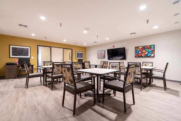 Dining area with tables and chairs at Park Visalia Assisted Living