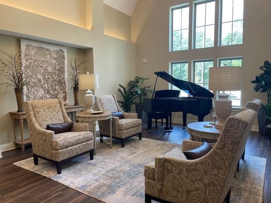 Inviting common area with elegant furniture and piano