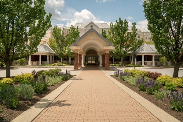 Walkway leading to the facility entrance surrounded by greenery