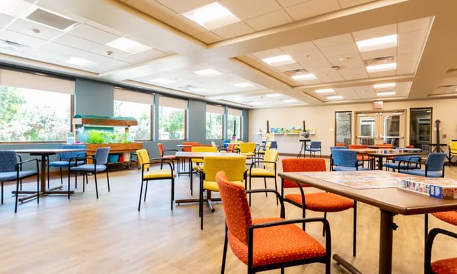 Bright and colorful common area with tables and chairs