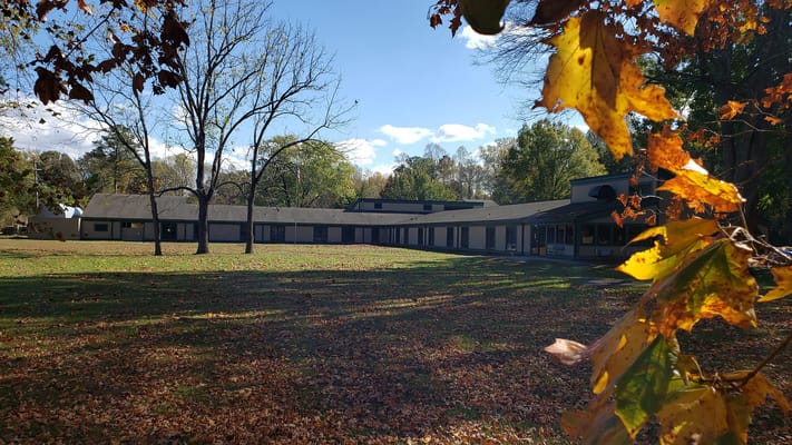 View of Riverside Lifelong Health facility surrounded by autumn leaves