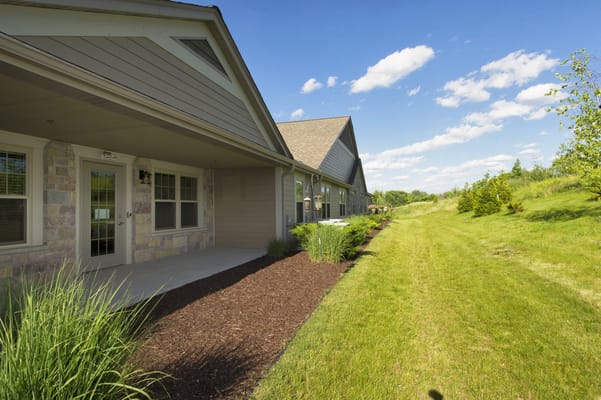 Exterior view showing a pathway and landscaped area at Robin's Landing.