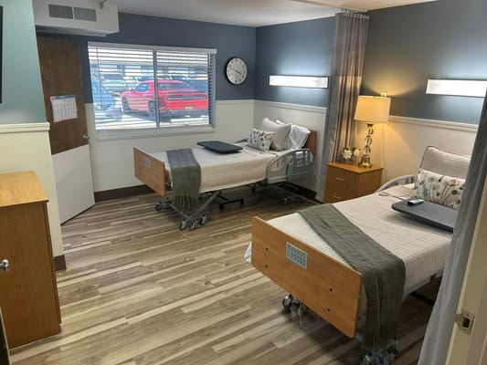 Cozy resident room with two beds and natural light