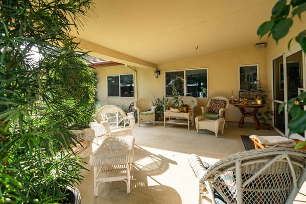 Outdoor seating area with wicker chairs and plants