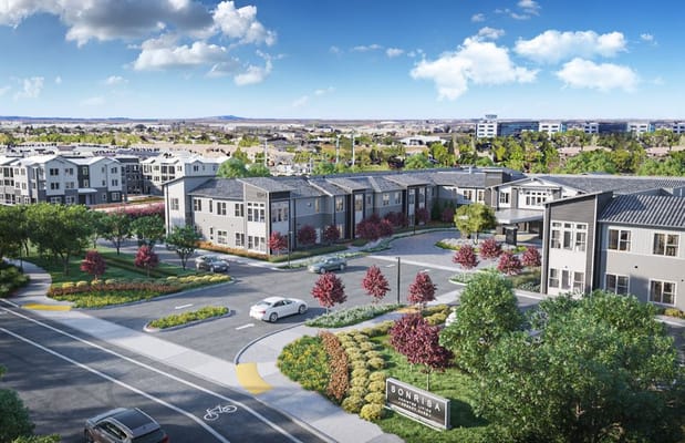 Aerial view of Sonrisa Senior Living facility with landscaped gardens and residential buildings.