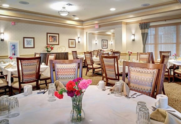 Dining room set with flowers and table settings
