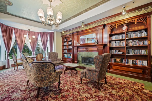 A beautifully decorated living room with comfortable seating and a bookshelf.