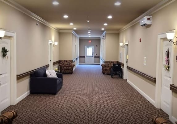 Hallway with seating areas in Symphony Assisted Living facility