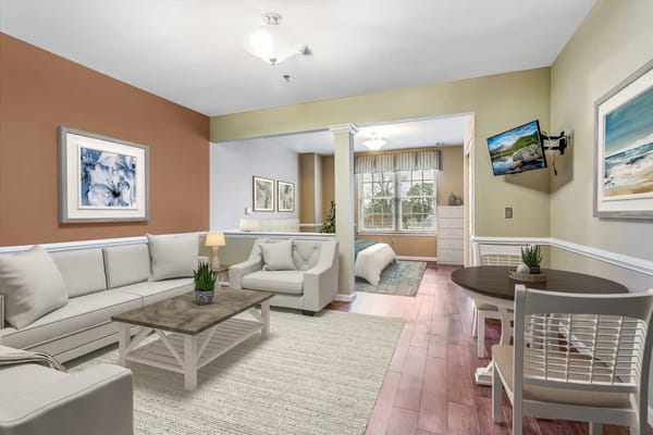 Bright and welcoming living room with comfortable seating and dining area.