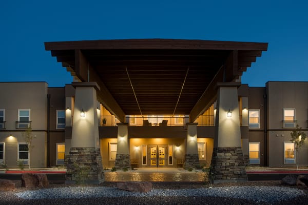 Exterior view of The Legacy at Cimarron illuminated at night.