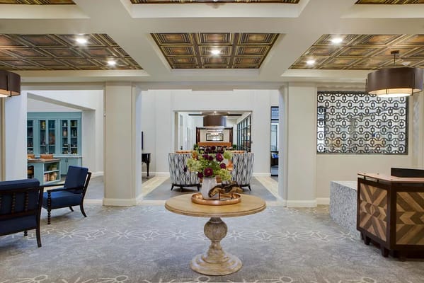 Lobby area featuring comfortable seating and decorative ceiling.