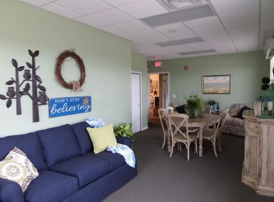 Living area with sofa, dining table, and wall decor