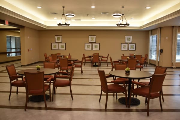 Seating area with tables and chairs in a common space.