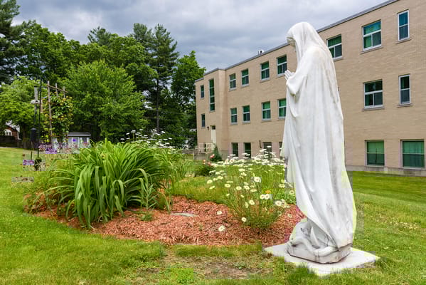 Statue in a garden area adjacent to the building