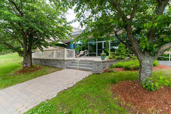 Exterior view of the facility entrance surrounded by greenery