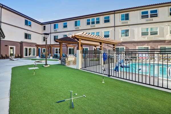 Outdoor recreational area with putting green and pool