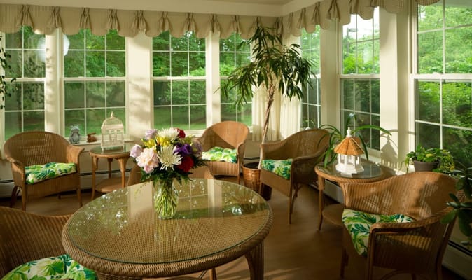 Bright sunroom with seating and plants