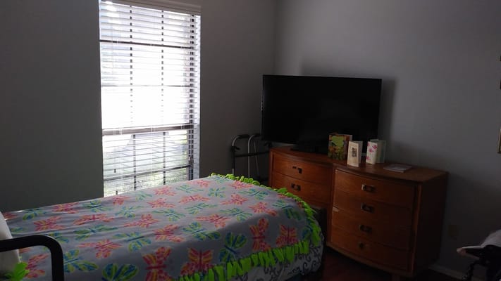 Cozy resident room with a window and furnishings