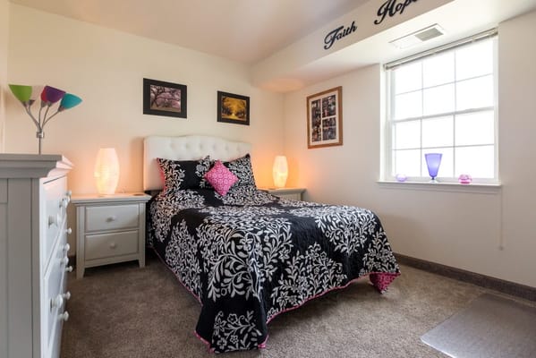 Cozy bedroom with decorative bedding and lamps