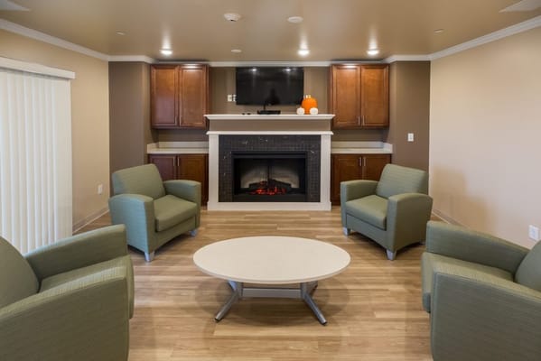 Cozy common area with chairs and a fireplace