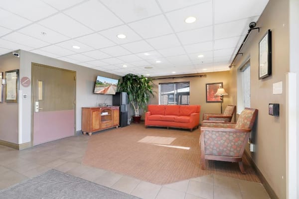 Bright common area with seating and TV
