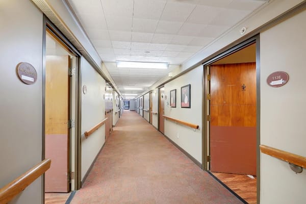 Interior hallway with resident doors and artwork