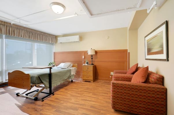 Private resident room with bed and seating area