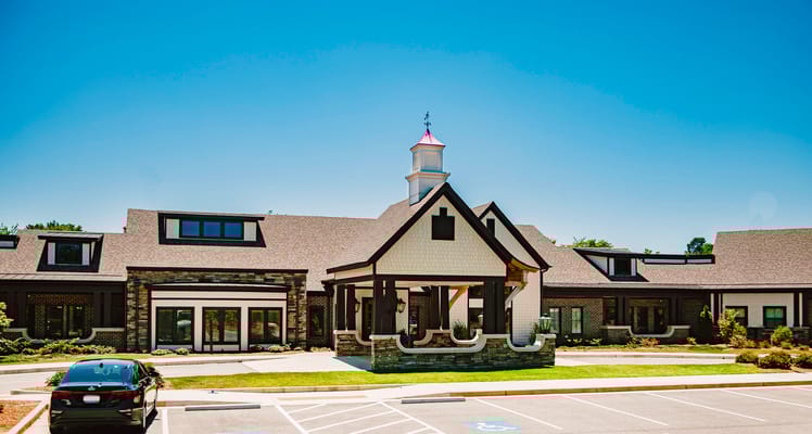 Exterior view of Aiken Memory Care facility with landscaped entrance
