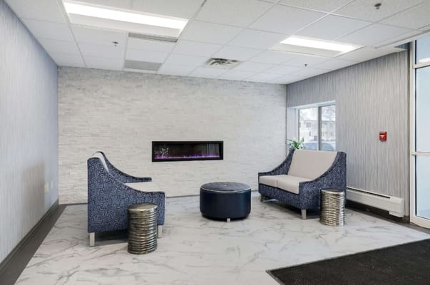 Lounge area with modern seating and flame wall feature