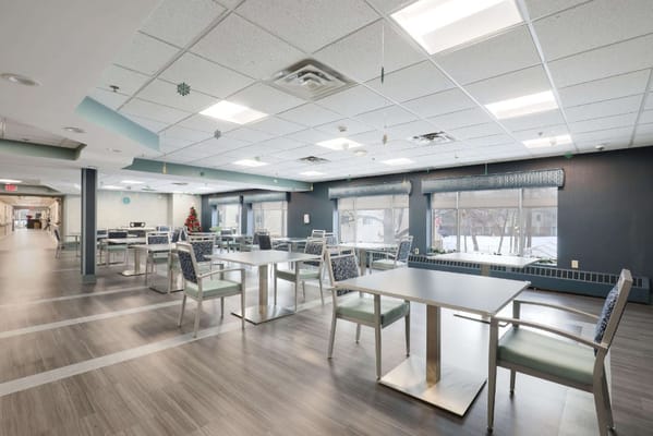 Bright dining area with tables and chairs at Southview Acres