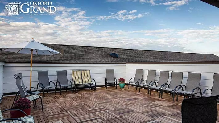 Comfortable seating area on the rooftop with chairs and umbrellas