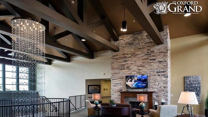 Spacious lobby with a chandelier and stone fireplace