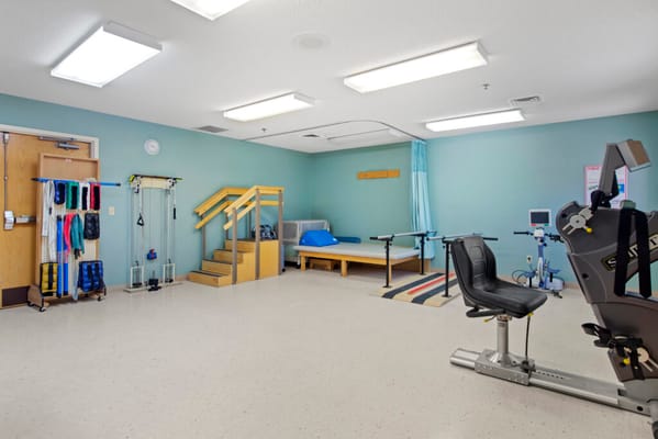 Rehabilitation gym with exercise equipment and therapy area