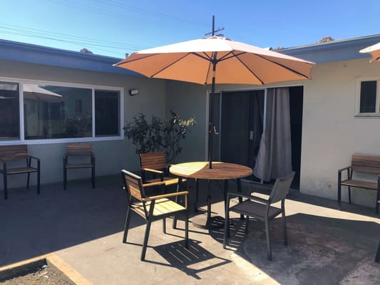 Outdoor seating area with tables and umbrellas