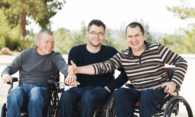 Three men in wheelchairs enjoying time outdoors