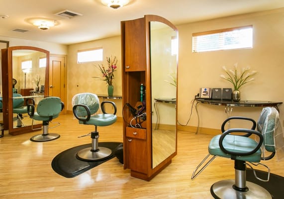 Interior of a beauty salon with styling chairs and mirrors