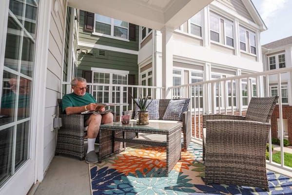 Resident enjoying a book on a balcony