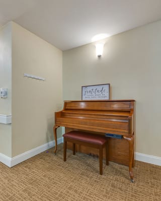 Inside view featuring a piano and wall decor