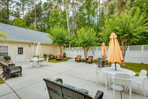 Outdoor seating area with umbrellas and greenery