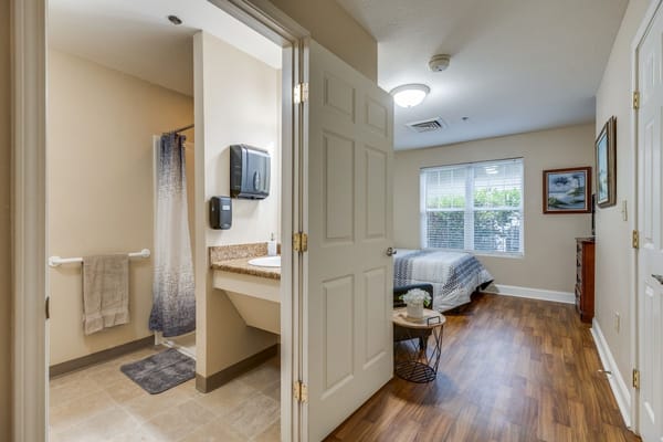 Private resident room with a bed and a bathroom