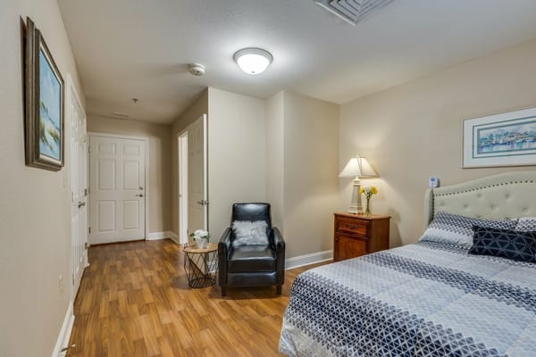 Private resident room with a bed and chair